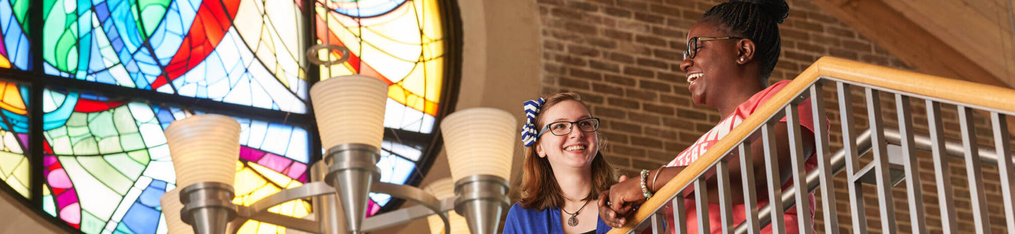 Ursuline college two women smiling on balcony2